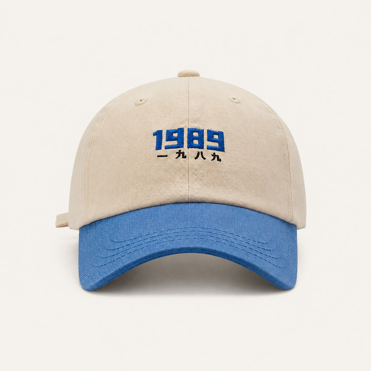 The Rue '89 Contrast Cap in Cream / Royal, straight-on front view.