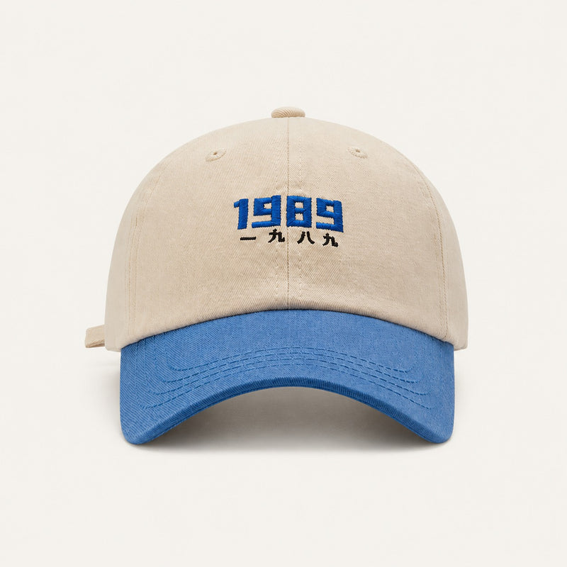 The Rue '89 Contrast Cap in Cream / Royal, straight-on front view.