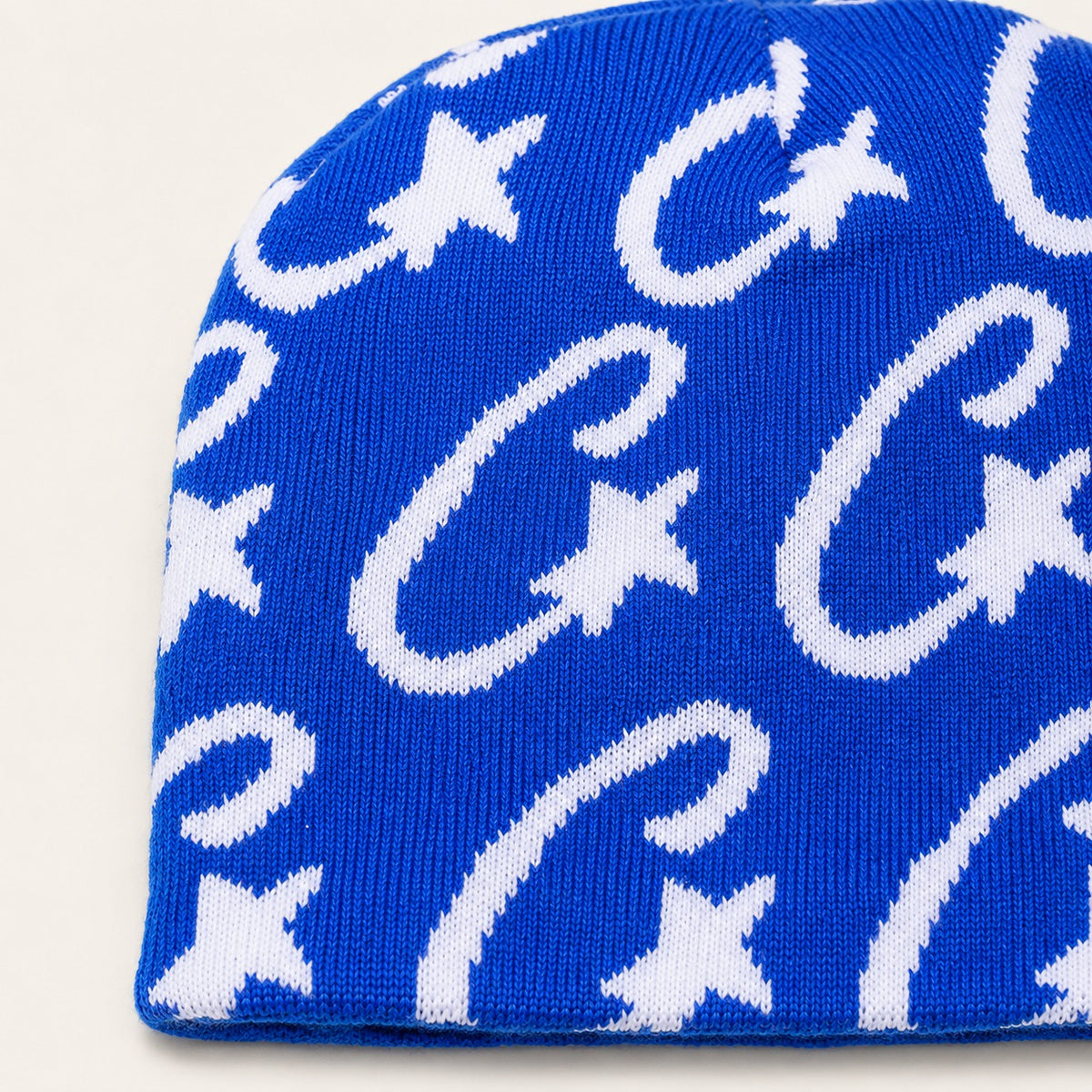 The Rue Signal Jacquard Beanie in Blue, fabric and hardware detail.