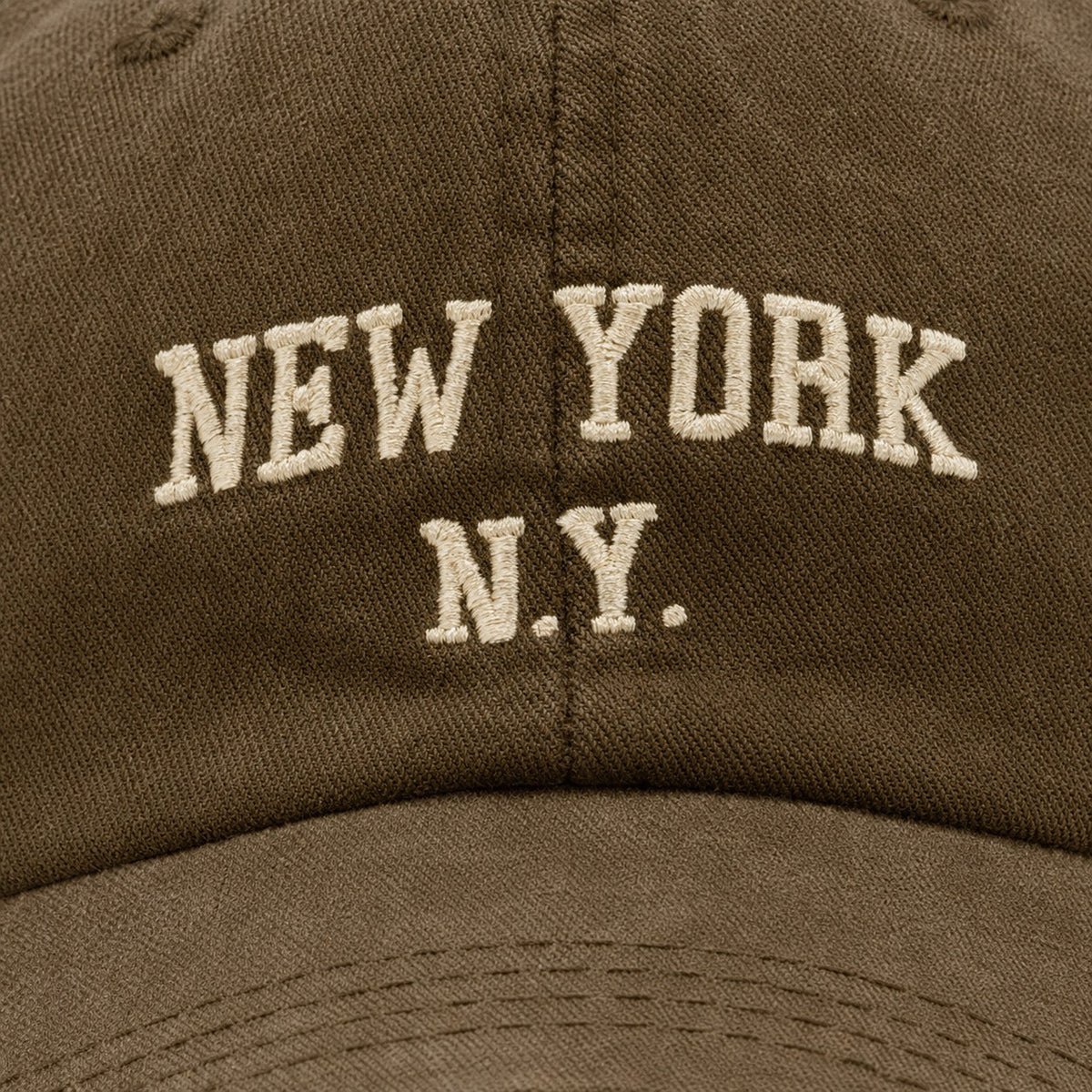The Rue New York Cap in Olive, fabric and hardware detail.