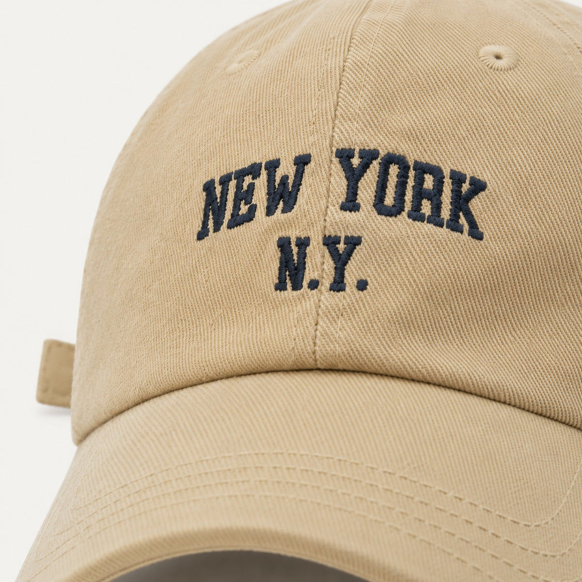 The Rue New York Cap in Sand, fabric and hardware detail.