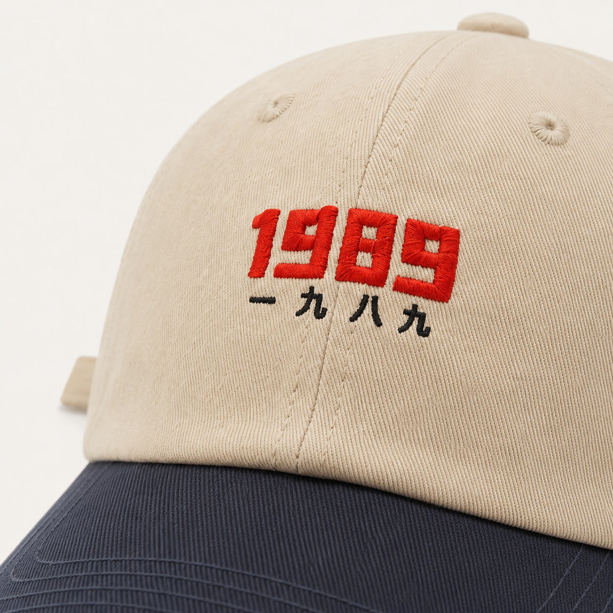 The Rue '89 Contrast Cap in Cream / Navy, fabric and hardware detail.