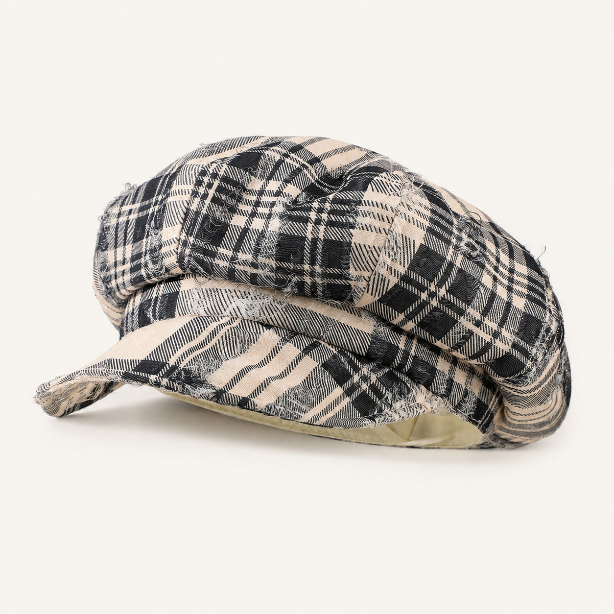 Rue Revival Plaid Newsboy Cap in Black Beige, front three-quarter view.