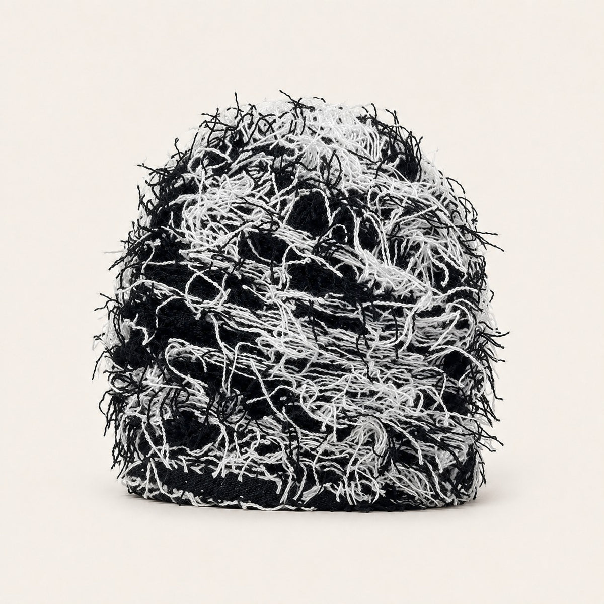 The Tangled Knit Beanie in Black And White, front three-quarter view.