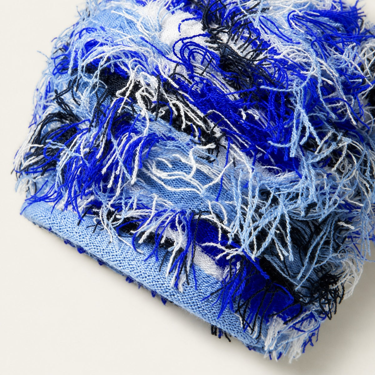 The Tangled Knit Beanie in Blue, fabric and hardware detail.