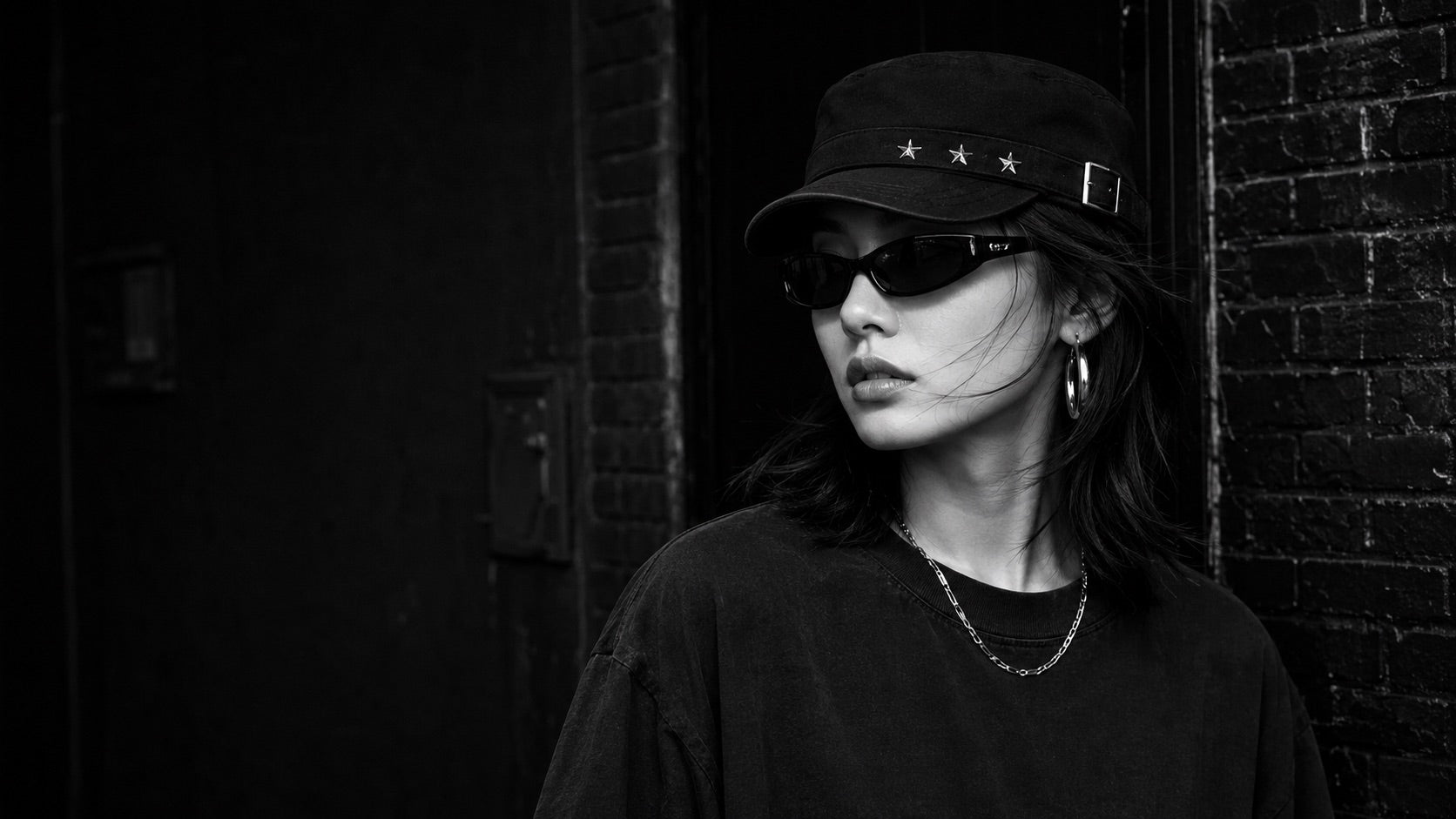 Model wearing the Rue Starcrossed Rivet Cadet Cap on a dark street
